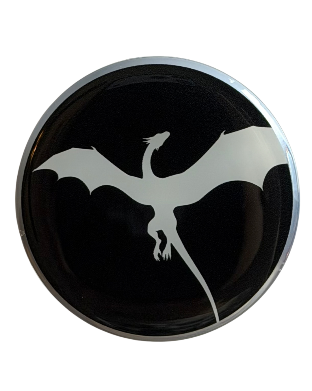 Round black magnetic grip with a white dragon design on a black background