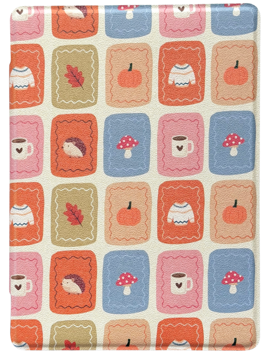 Patterned Case for kindle and kobo with colorful squares featuring items like cups, pumpkins, and mushrooms on a beige background. the book girl club 