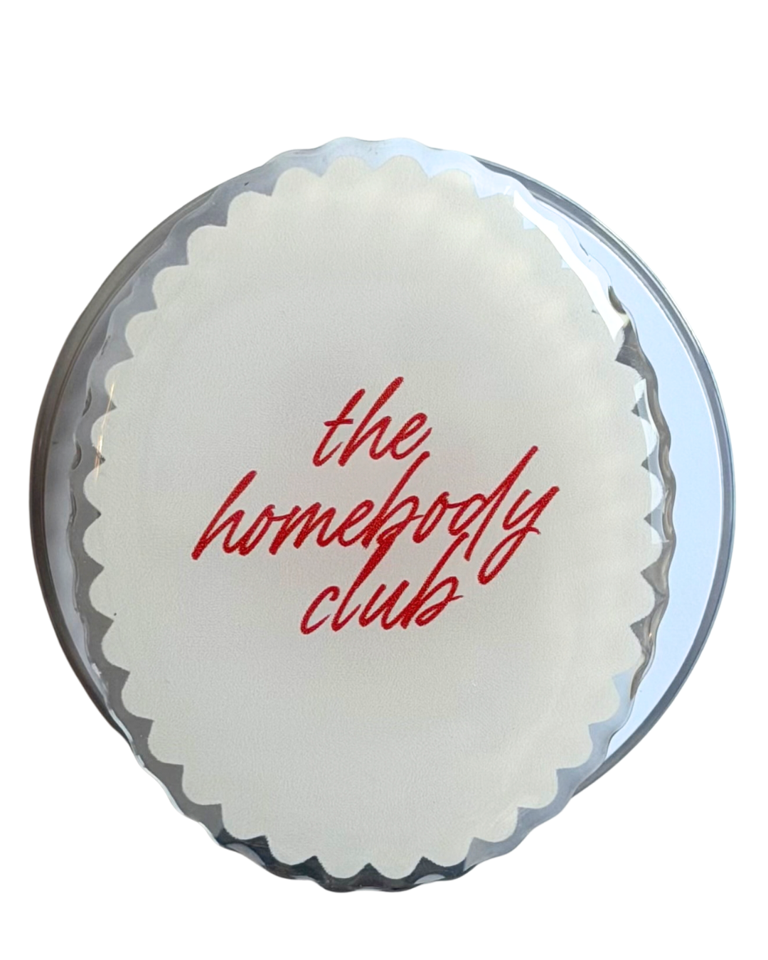 Round magnetic grip with 'the homebody club' text in red on a white/cream background